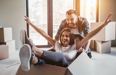 A young couple celebrates their new home.