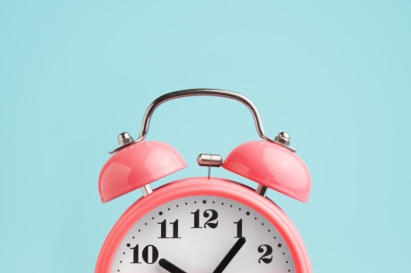 Red alarm clock on ablue background