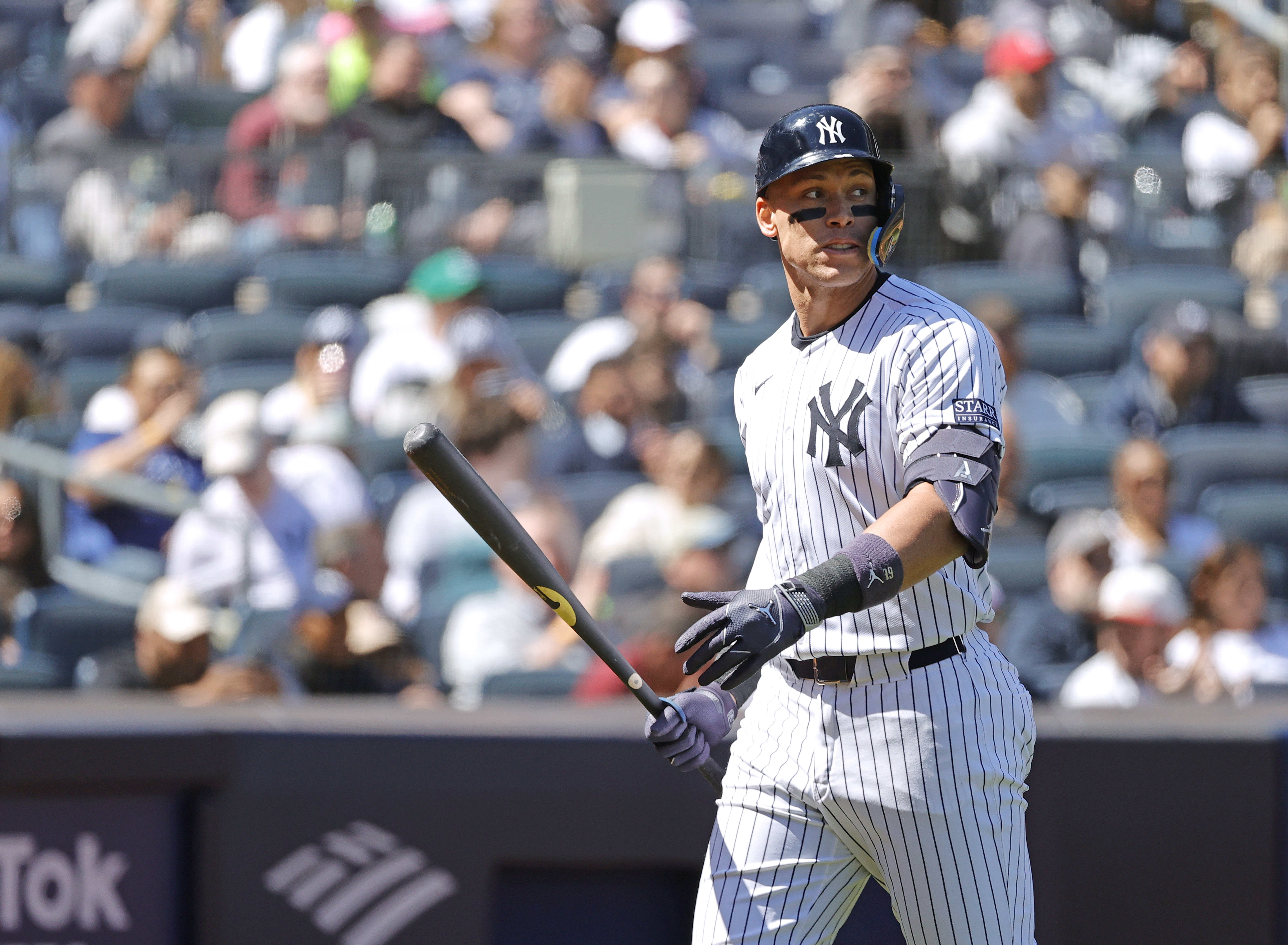 Aaron Judge #99 of the New York Yankees reacts as he walks back to the dugout after he strikes out swinging during the 4th inning.