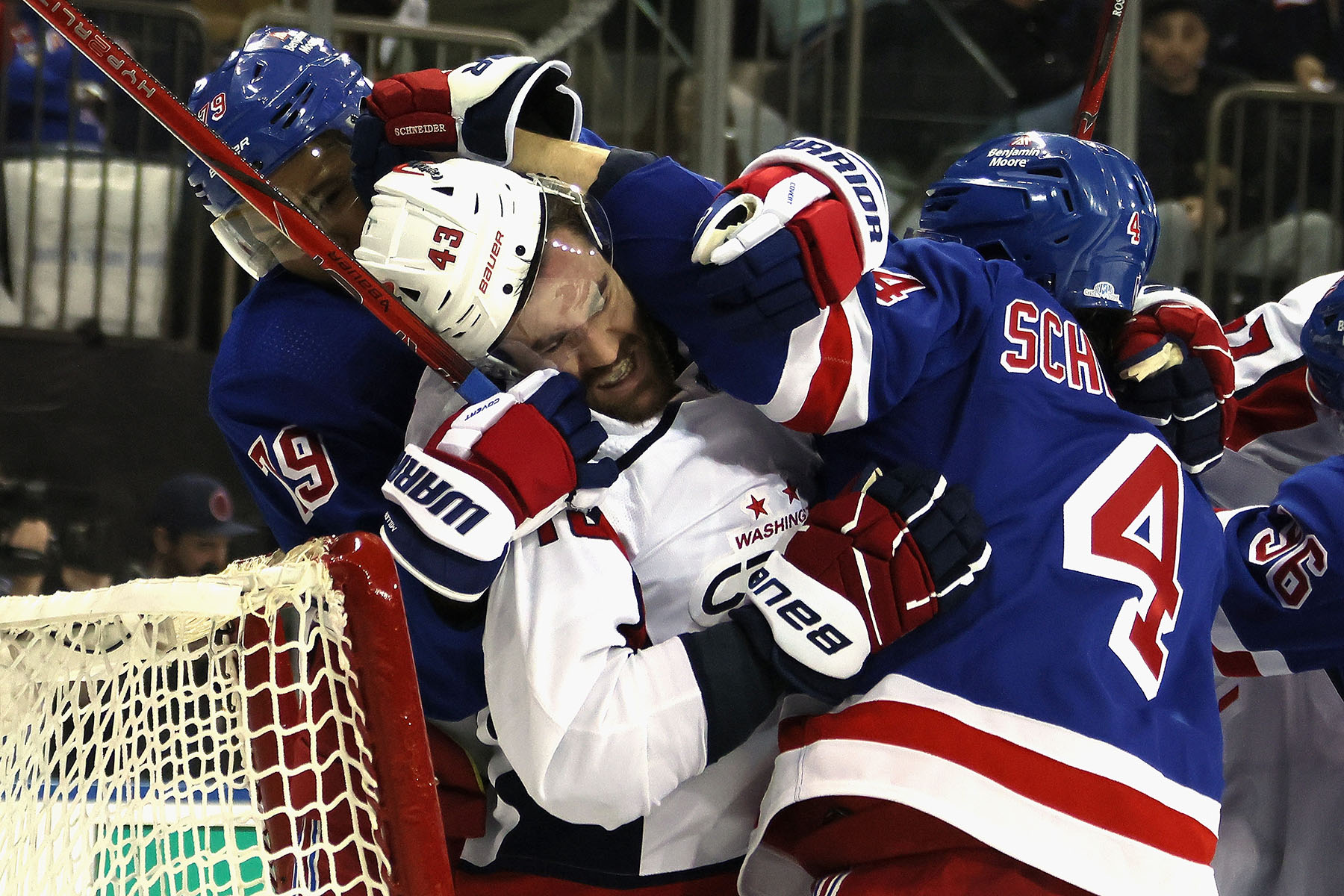 K'Andre Miller #79 and Braden Schneider #4 of the New York Rangers battle with Tom Wilson #43 of the Washington Capitals late in the third period in Game One of the First Round of the 2024 Stanley Cup Playoffs at Madison Square Garden on April 21, 2024 in New York City. The Rangers defeated the Capitals 4-1.