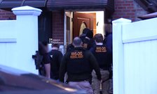 HHS OIG federal agents entering a home through the front door