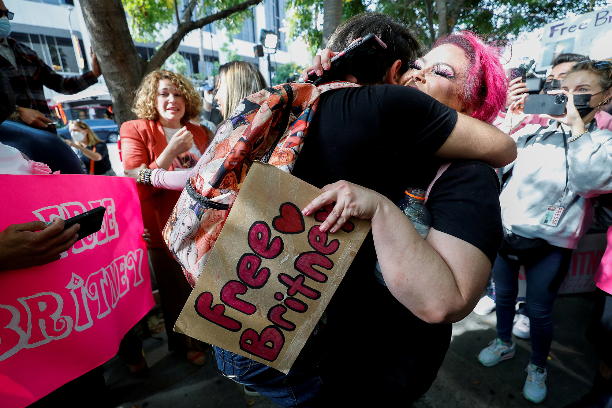 Supporters of pop star Britney Spears hug as they celebrate