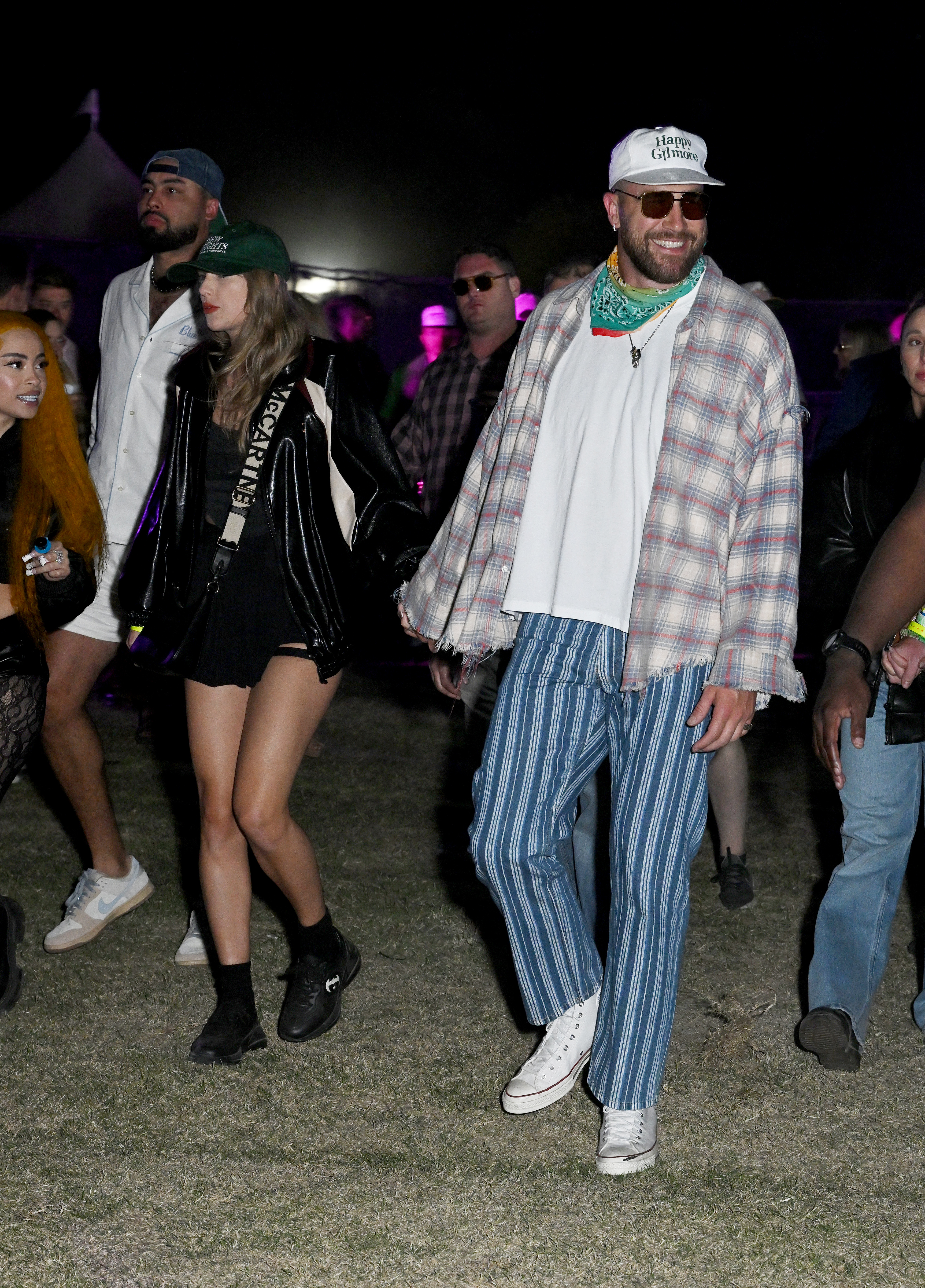 taylor swift and travis kelce walking through coachella