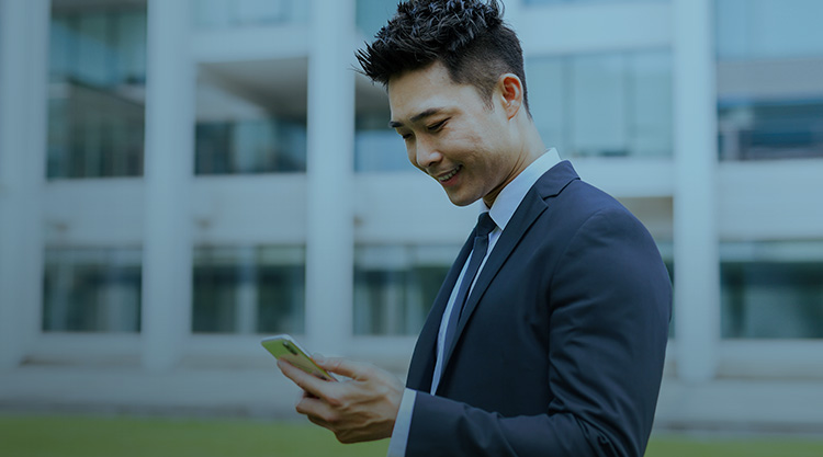 Portrait of Asian businessman using phone.