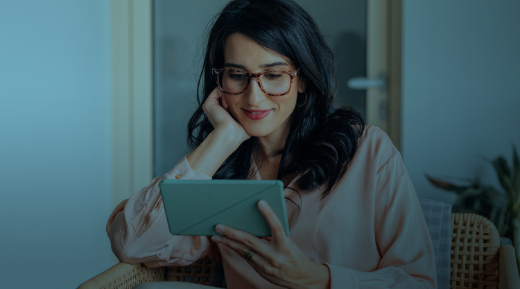 Happy Businesswoman Using a Digital Tablet at Work