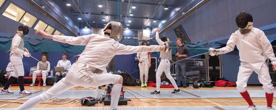 Two students participating in a fencing match in Ethos