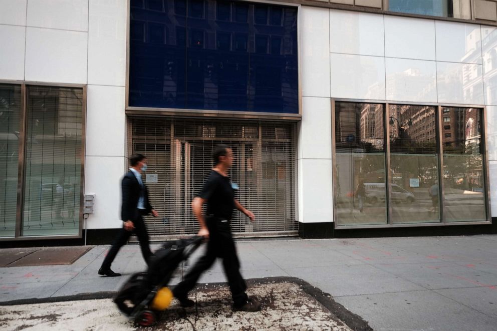 PHOTO: People walk past a closed Gap store in a Manhattan shopping district on Aug. 12, 2020, in New York City.