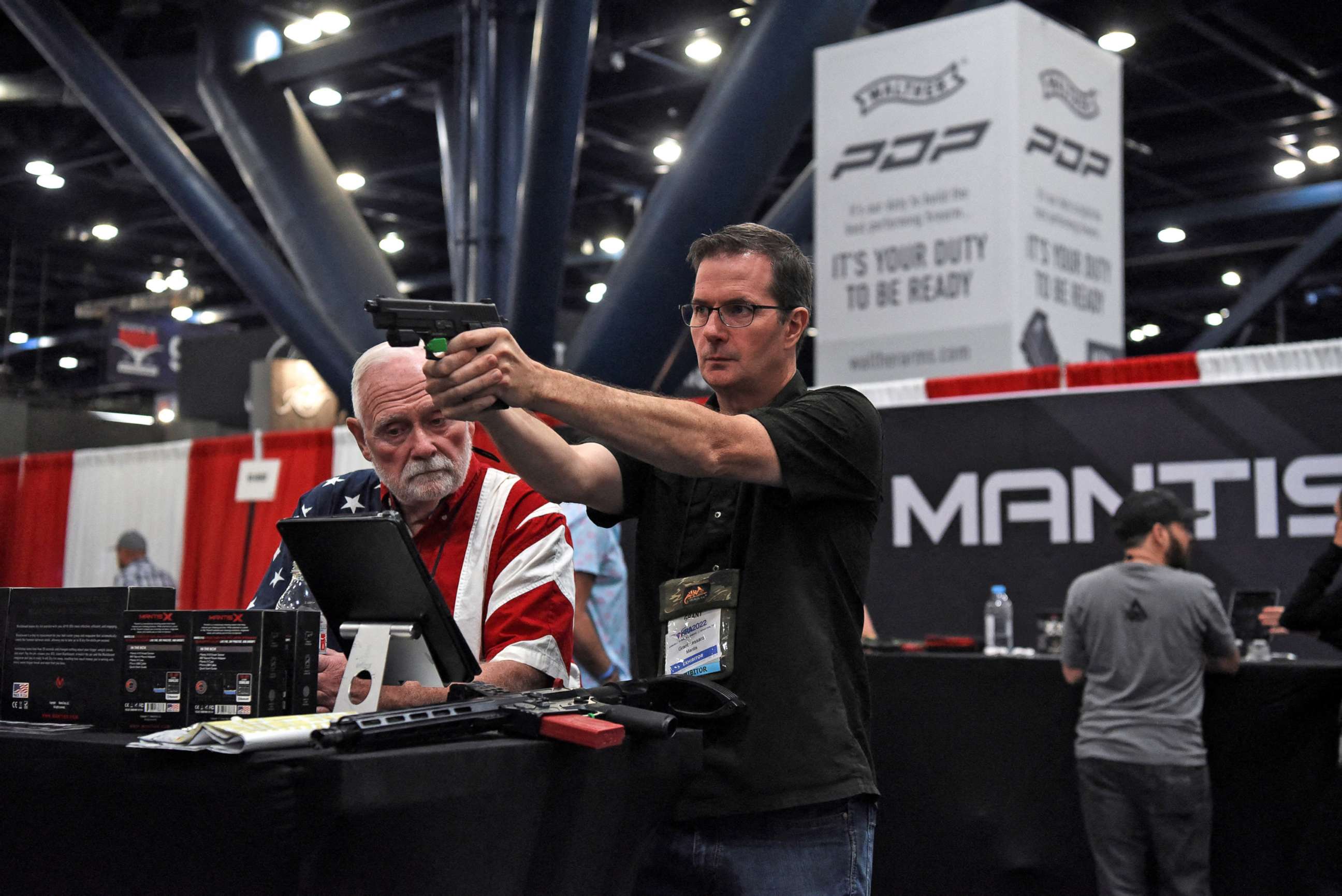 PHOTO: An attendee tries out a gun on display at the National Rifle Association (NRA) annual convention in Houston, May 29, 2022. 