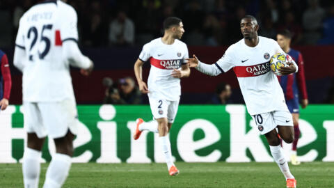 Paris Saint-Germain's French forward Ousmane Dembele celebrates after scoring his team's first goal during the UEFA Champions League quarter-final in Barcelona on April 16, 2024.