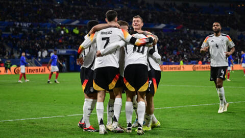 Germany's players celebrate after scoring their second goal against France at the Groupama Stadium in Lyon on March 23, 2024.