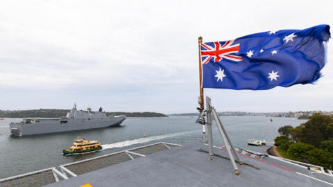 This handout photo taken and released by the Royal Australian Navy and the Australian Defence Force on January 18, 2022, shows defence is pre-positioning HMAS Adelaide to Brisbane.