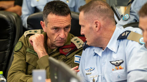 The head of the military, Lieutenant General Herzi Halevi (L), attending an early meeting on April 14, 2024 at the Israeli Air Force Operations Center in Kirya in Tel Aviv with the commanding officers