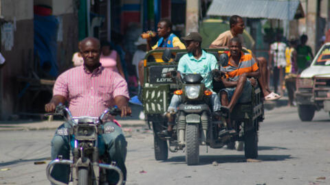 People drive their motorcycles in the street in Port-au-Prince, Haiti, on March 12, 2024.