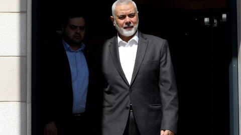 This handout picture provided by the Iranian foreign ministry on February 13, 2024 shows Hamas's political bureau chief Ismail Haniyeh preparing to welcome the Iranian foreign minister in Doha, Qatar.