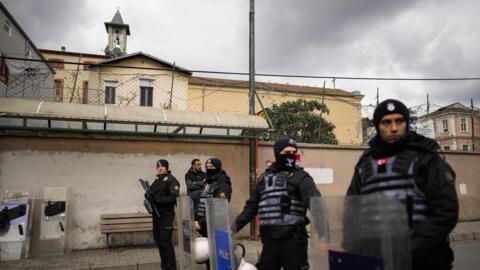 Turkish police officers stand guard in a cordoned off area outside the Santa Maria church, in Istanbul, Turkey on January 28, 2024.