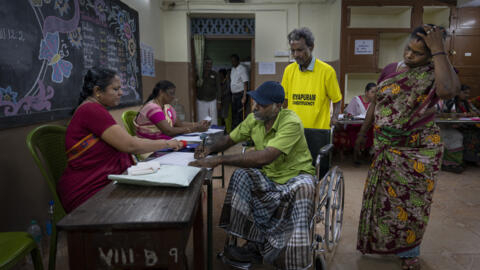 A man on a wheelchair prepares to cast vote during the first round of voting of India's national election in Chennai, southern Tamil Nadu state, Friday, April 19, 2024.