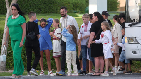Ukrainian children and their families arrive to meet with Qatari minister of state for international cooperation (not pictured) in Doha on April 24, 2024. 