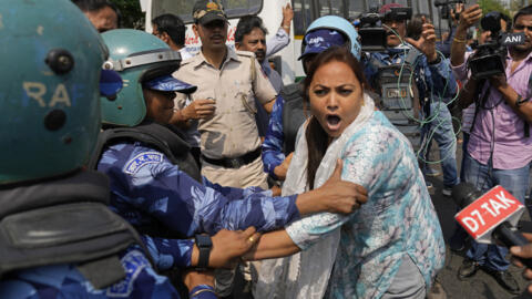 Rapid Action Force personnel detain a supporter of Aam Admi Party, or Common Man's Party, during a protest against the arrest of their party leader Arvind Kejriwal, in New Delhi, India, Friday, March
