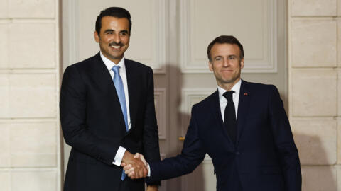 French President Emmanuel Macron (R) shakes hands with Qatar's Emir Sheikh Tamim bin Hamad al-Thani during an agreement signing ceremony at the Elysee Palace, in Paris on February 27, 2024.