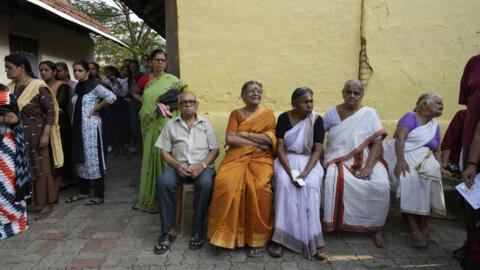 Elderly voters sit out a line to vote in the second phase of national elections in Indian southern state of Kerala, April 26, 2024.