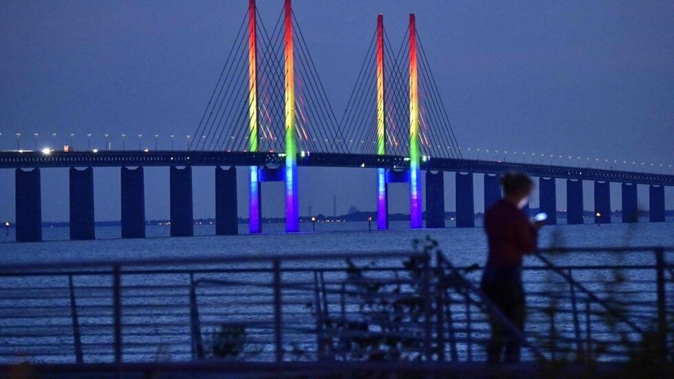 The Oresund Bridge between Denmark and Sweden is illumniated in the Pride colors in Malmo on August 12, 2021.