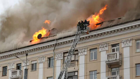 Firefighters battle flames in a building hit by a Russian strike on April 19, 2024 in Dnipro, central-eastern Ukraine.
