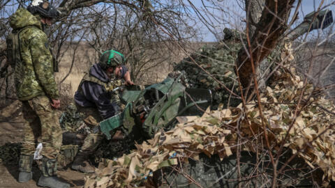 Ukrainian service members fire a 120-mm towed 2B16 "Nona-K" artillery-piece mortar towards Russian troops, amid Russia's attack on Ukraine, near the town of Bakhmut in Donetsk region, Ukraine March 8,