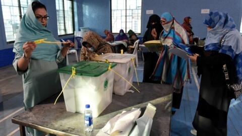 Polling staff opens the ballot boxes in presence of poling agents from various political parties as they start counting votes at the end of country's national elections in Quetta on February 8, 2024. 