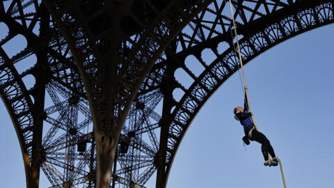 French athlete Anouk Garnier rope climbs up the Eiffel Tower in a bid to break the world record, at the Eiffel Tower in Paris, on April 10, 2024.
