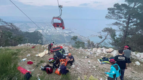 Rescue teams conduct a rescue operation and help injured people after a cable car cabin crashed into a fallen cable pole in the Konyaalti district of Antalya, Turkey on April 12, 2024. 
