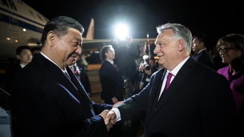 Chinese President Xi Jinping, left, shakes hands with Hungarian Prime Minister Viktor Orban at the Liszt Ferenc International Airport in Budapest, Hungary, Wednesday, May 8, 2024
