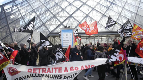 French pension reform protestors demonstrate outside the Louvre museum on March 27, 2023 in Paris.
