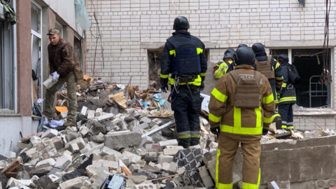 Ukrainian rescuers clear the rubble of a destroyed building following a missile attack in Chernigiv on April 17, 2024.