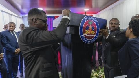 Officials set up the podium before the the swearing-in ceremony of the transitional council tasked with selecting Haiti's new prime minister and cabinet, in Port-au-Prince, Haiti, April 25,