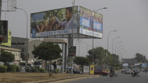 Cars drive past election posters of Togo's incumbent President Faure Gnassingbe, presidential candidate of Union for the Republic, on the street in Lome, Togo on February 21, 2020.