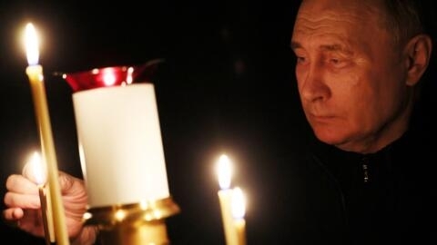 In this pool photograph distributed by the Russian state agency Sputnik, Russia's President Vladimir Putin lights a candle during his visit to a church outside Moscow on March 24, 2024.