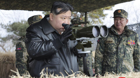 North Korean leader Kim Jong Un, left, supervises artillery firing drills in North Korea Thursday, March 7, 2024.