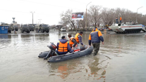 Rescuers ride a boat in a flooded street of Orsk, Russia on April 9, 2024, in this still image taken from video.