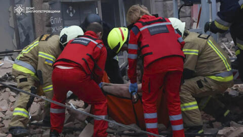 In this photo provided by the Ukrainian Emergency Service, rescuers and ambulance workers carry a person on the scene of a Russian attack in Dnipro, Ukraine, Friday, April 19, 2024.