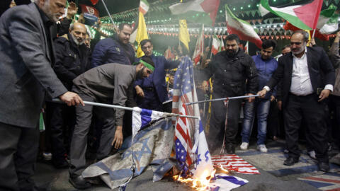 Iranians burn Israeli and US flags during a protest at Palestine square in Tehran, Iran on April 1, 2024.