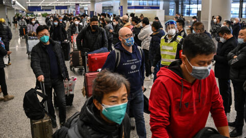 Passengers are seen in the arrivals area for international flights at the Shanghai Pudong International Airport in Shanghai. 