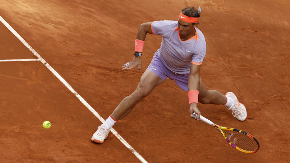 Rafael Nadal returns the ball to teenager Darwin Blanch during the Spaniard's first round win in his final Madrid Open appearance