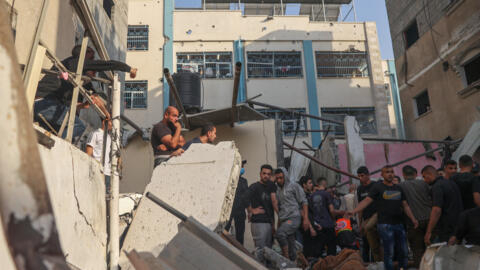 Palestinians search for casualties in the rubble of a house destroyed in an Israeli strike on Rafah, in the southern Gaza Strip.