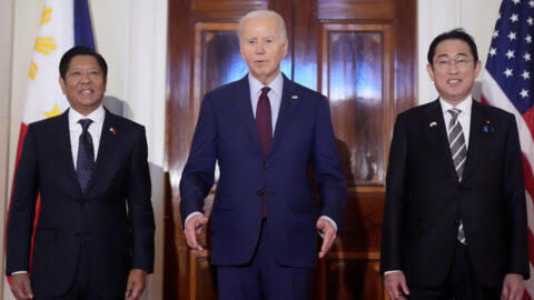 US President Joe Biden (C) speaks alongside Philippine President Ferdinand Marcos Jr. (L) and Japanese Prime Minister Fumio Kishida in the East Room of the White House on April 11, 2024.