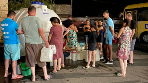 The residents of Stepanakert stand in line at night to obtain bread and water in Nagorno-Karabakh, since access to the region has been blocked by Azerbaijan.