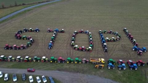 An aerial view shows tractors positioned to read "STOP !" during a farmers' protest in Maille, central France, on 23 January, 2024.