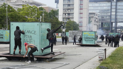 Young people throwing objects at police in Nanterre, outside Paris, during riots in June 2023. 