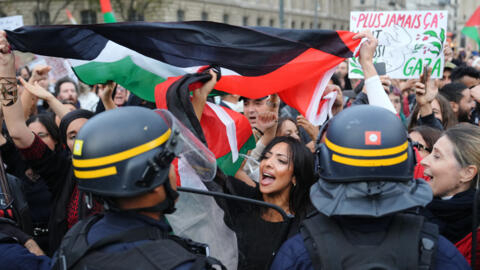 Protesters face elite French police officers during a demonstration in support of Palestinians at Place de la Republique in Paris on 19 October, 2023.