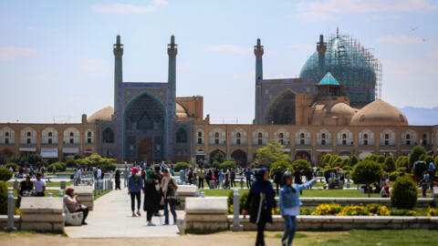 People visit the Naqsh-e Jahan Square in front of the Shah Mosque in Iran's central city of Isfahan on 19 April 2024.