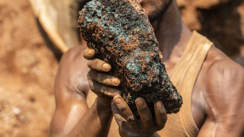 A miner holds a cobalt stone at the Shabara mine near Kolwezi in the Democratic Republic of Congo, on 12 October 2022.